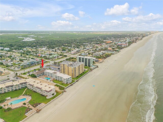 birds eye view of property with a water view and a view of the beach