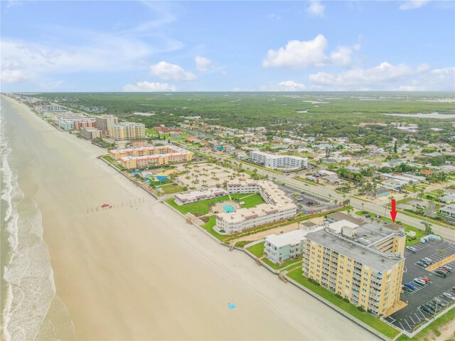 drone / aerial view featuring a water view and a beach view