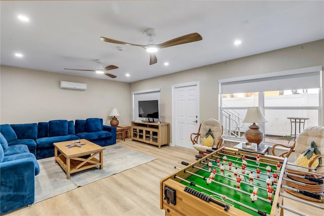 living room with a wall mounted air conditioner and hardwood / wood-style floors