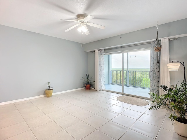 empty room featuring light tile patterned flooring, ceiling fan, and a textured ceiling