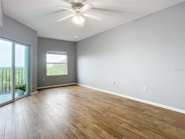 unfurnished room with ceiling fan, a textured ceiling, and light hardwood / wood-style floors