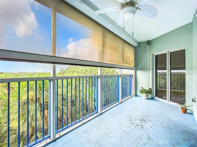 unfurnished sunroom featuring a wealth of natural light and ceiling fan