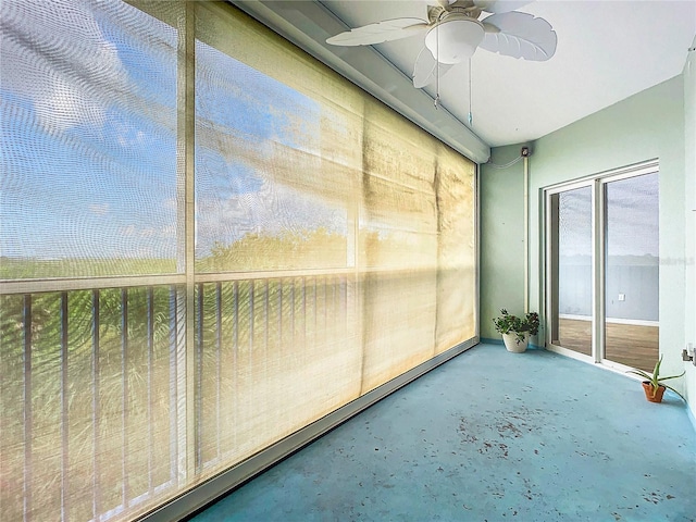 unfurnished sunroom with ceiling fan