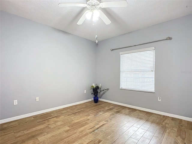 empty room with ceiling fan, a textured ceiling, and light wood-type flooring