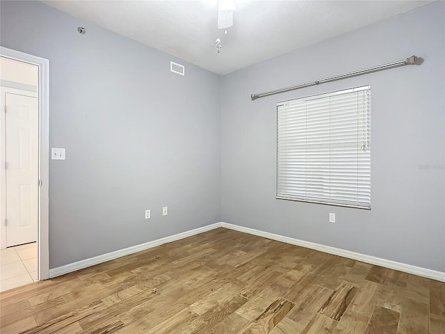 spare room featuring light wood-type flooring