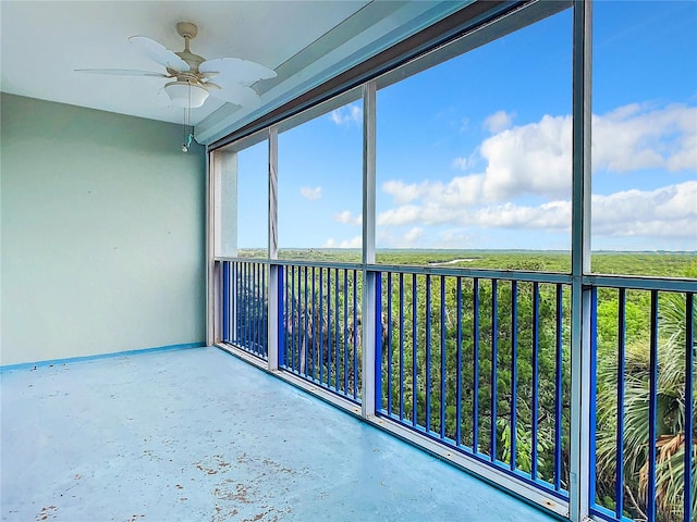 unfurnished sunroom featuring ceiling fan