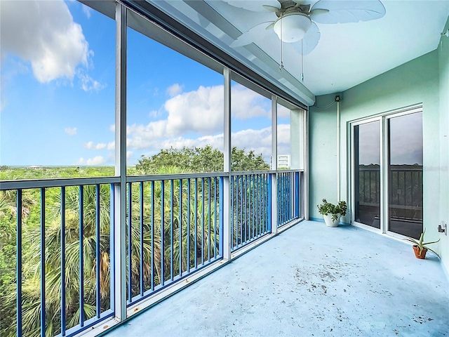 unfurnished sunroom with ceiling fan