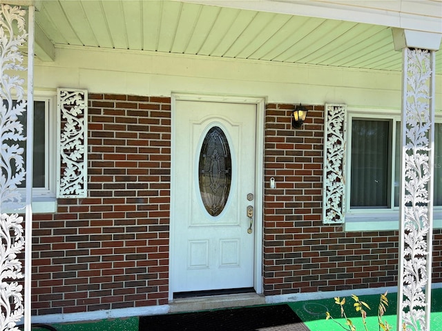 property entrance with brick siding