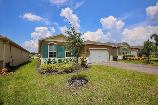 single story home featuring a garage and a front lawn