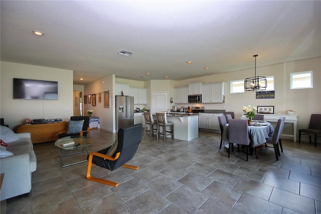 dining space with tile patterned flooring and an inviting chandelier