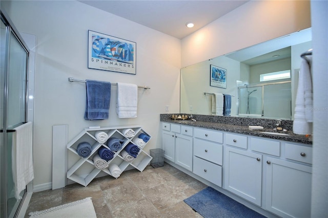 bathroom featuring double sink vanity, walk in shower, and tile patterned flooring