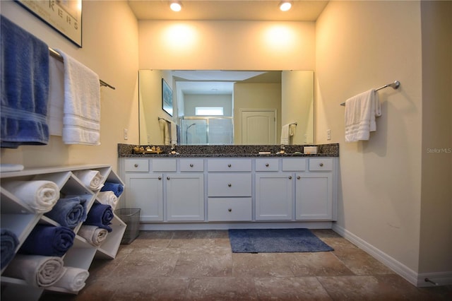 bathroom with tile patterned floors and double vanity