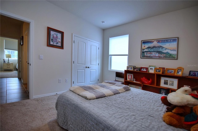 bedroom with carpet and a closet