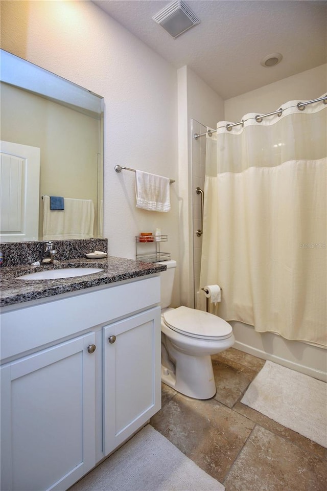 full bathroom with shower / tub combo, vanity, tile patterned flooring, and toilet