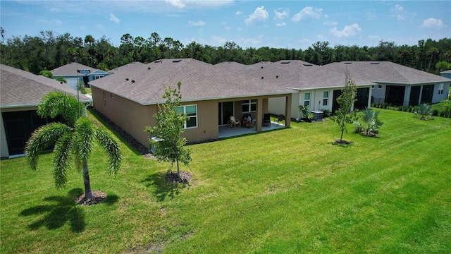 rear view of property featuring a patio, central AC unit, and a yard