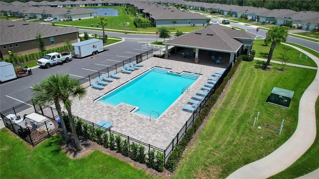 view of pool featuring a lawn and a patio area