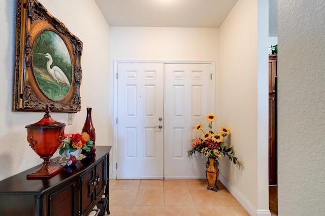 foyer entrance with light tile patterned flooring