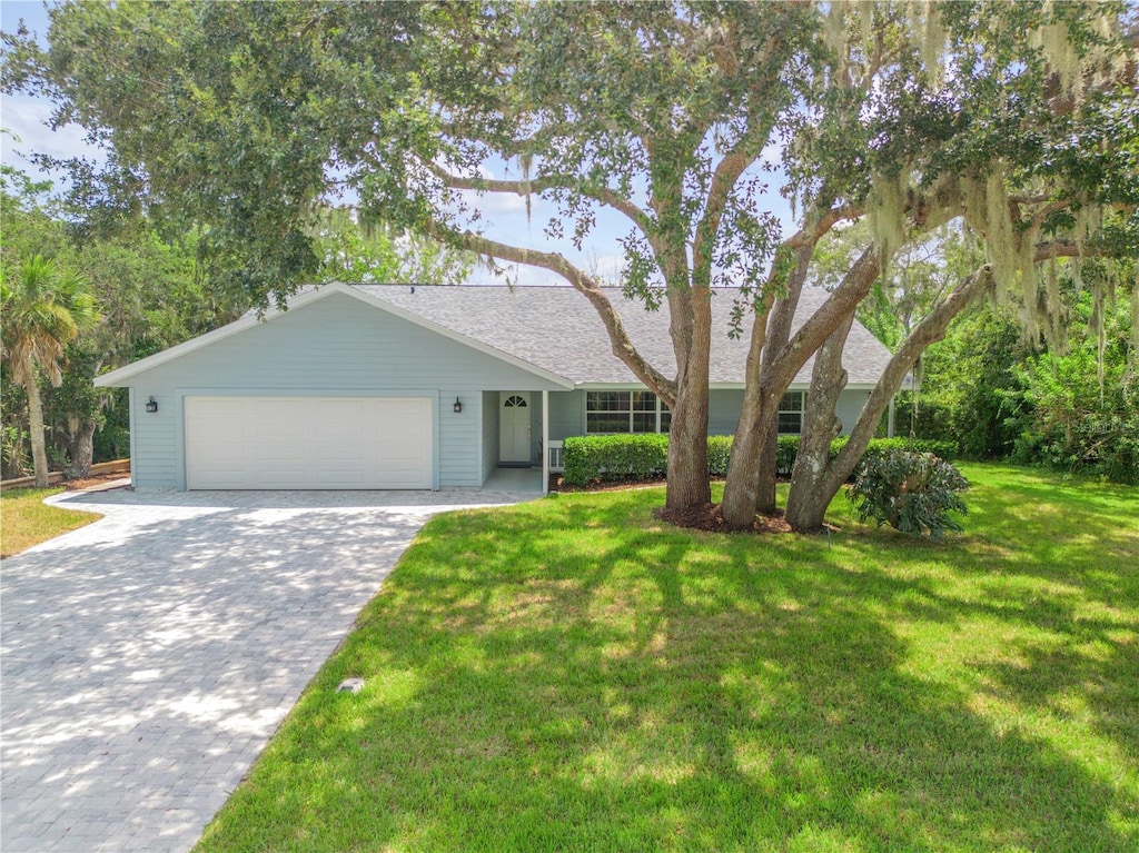 ranch-style house with a front yard and a garage