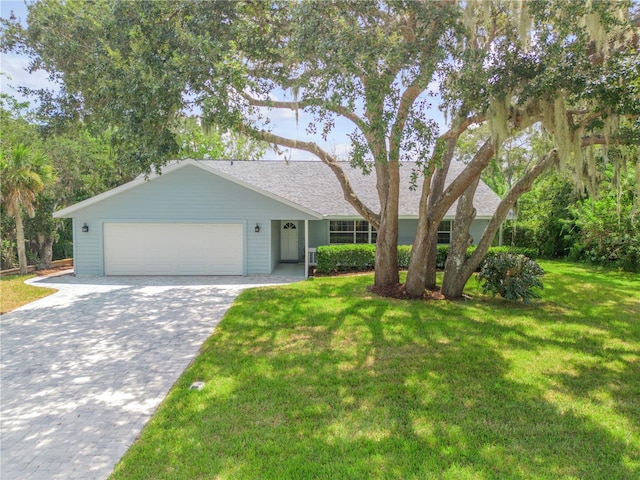 ranch-style house with a front yard and a garage