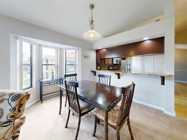 view of carpeted dining space