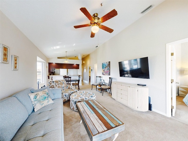 carpeted living room featuring ceiling fan and high vaulted ceiling