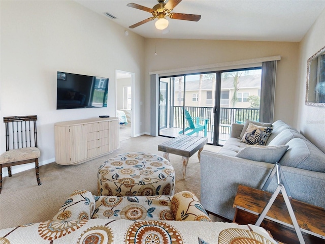 carpeted living room with vaulted ceiling and ceiling fan