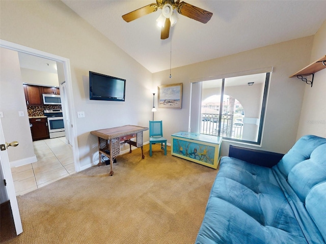 living room featuring ceiling fan, lofted ceiling, and light carpet