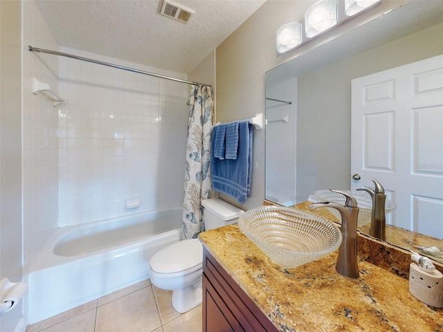 full bathroom featuring toilet, a textured ceiling, vanity, shower / bath combo with shower curtain, and tile patterned flooring