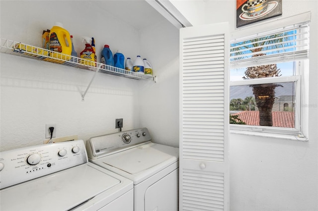 clothes washing area featuring independent washer and dryer