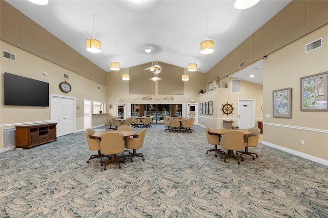 carpeted living room with high vaulted ceiling