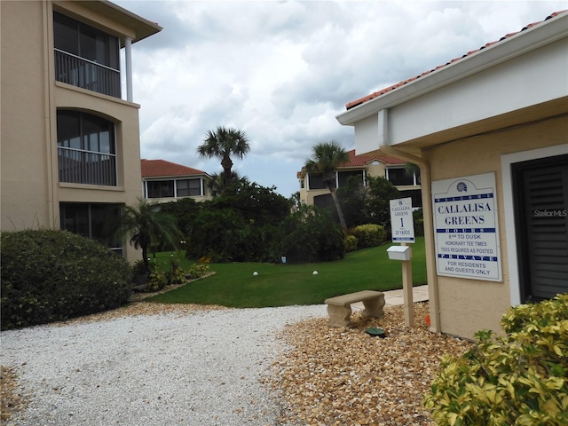 view of home's community with a yard