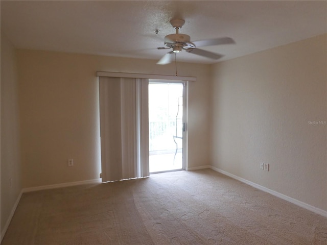 empty room featuring ceiling fan and carpet floors