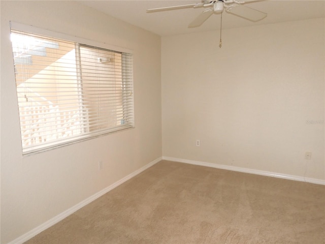 carpeted empty room with ceiling fan