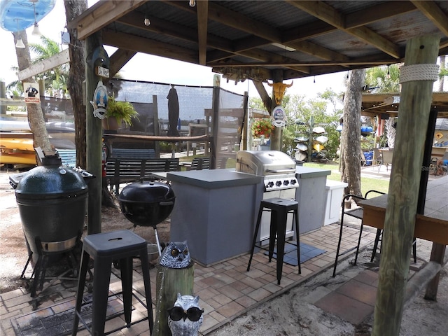 view of patio / terrace featuring an outdoor kitchen and a grill