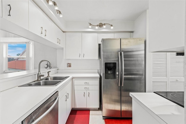 kitchen featuring white cabinetry, stainless steel appliances, and sink