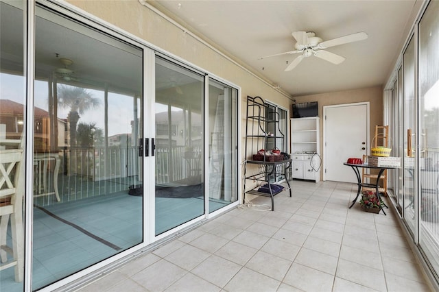 unfurnished sunroom with ceiling fan and a healthy amount of sunlight