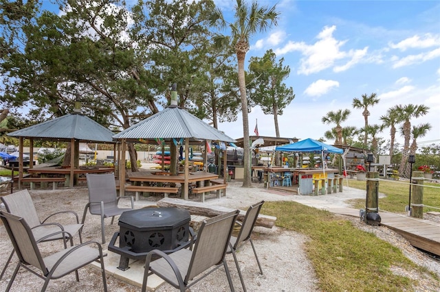 view of patio / terrace with an outdoor fire pit and a gazebo