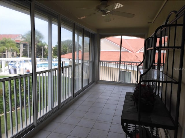 unfurnished sunroom featuring plenty of natural light and ceiling fan