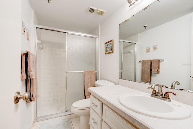 bathroom featuring tile patterned flooring, toilet, an enclosed shower, and vanity