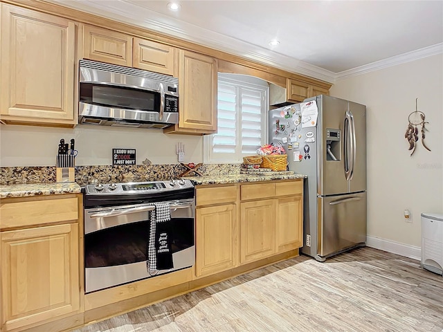 kitchen with appliances with stainless steel finishes, ornamental molding, light stone counters, and light brown cabinetry