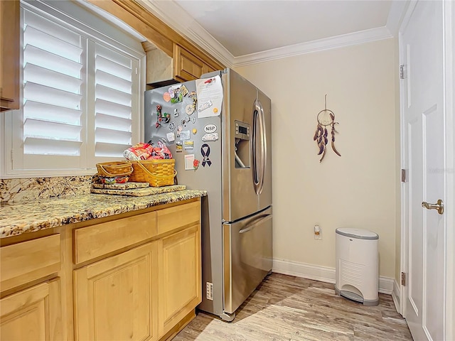 kitchen featuring light stone countertops, crown molding, light brown cabinets, stainless steel fridge with ice dispenser, and light hardwood / wood-style floors