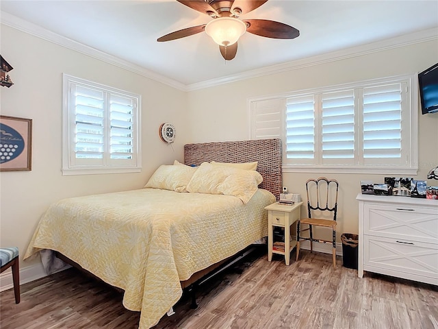 bedroom with light hardwood / wood-style floors, ceiling fan, and crown molding