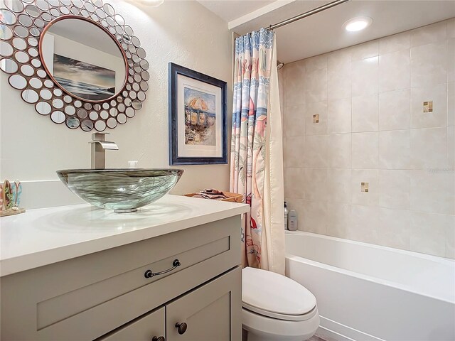 full bathroom with shower / bath combo, vanity, and toilet