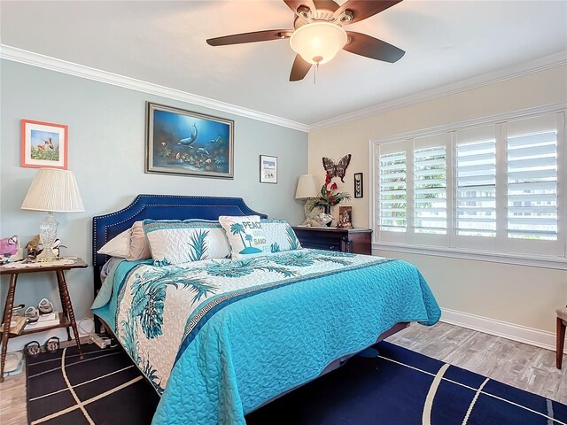 bedroom featuring ceiling fan, crown molding, baseboards, and wood finished floors