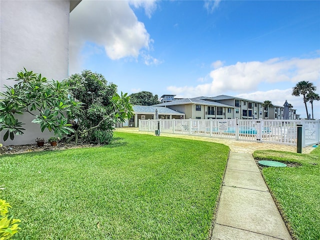 view of yard with a fenced in pool and fence