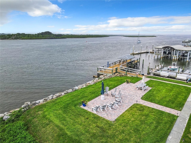 exterior space featuring a patio area, a water view, a yard, and boat lift