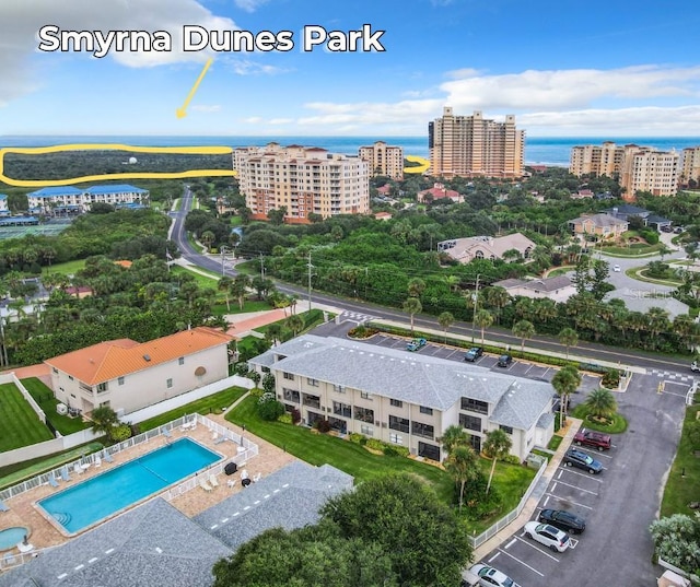 birds eye view of property featuring a water view and a city view