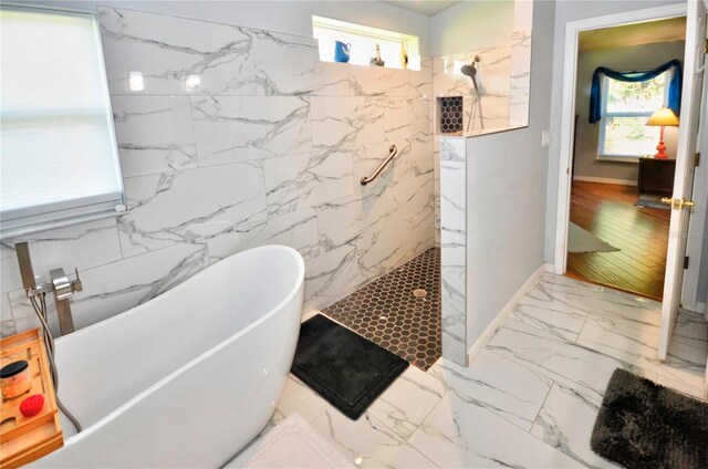 bathroom featuring hardwood / wood-style flooring, shower with separate bathtub, and tile walls