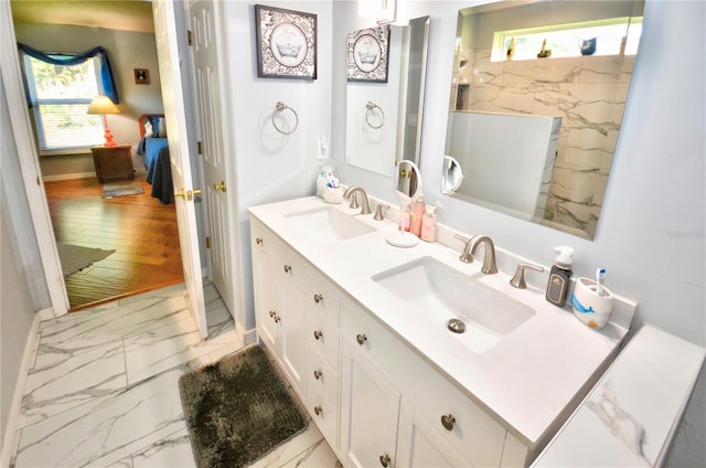 bathroom featuring hardwood / wood-style flooring and dual vanity