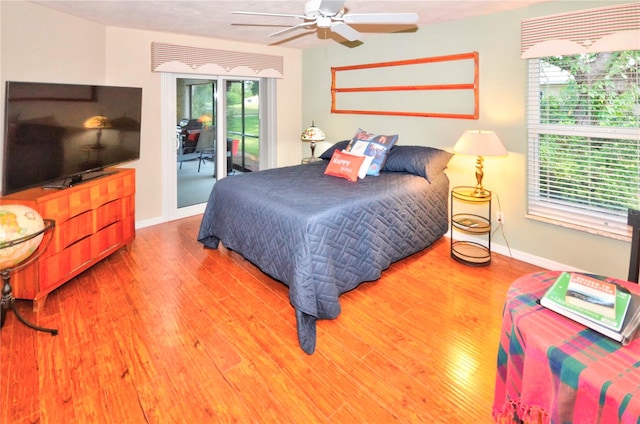 bedroom with hardwood / wood-style flooring, access to exterior, and ceiling fan